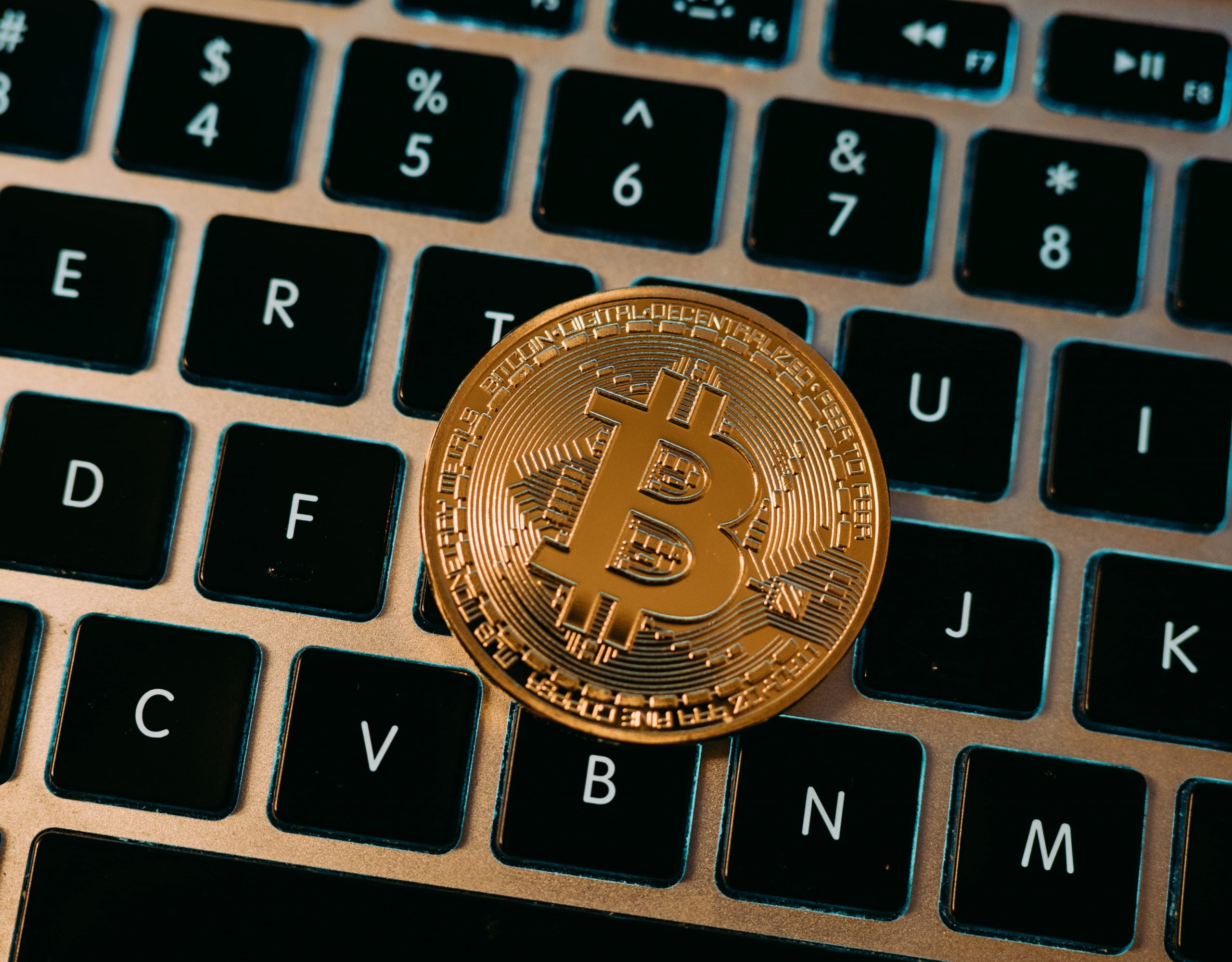 bitcoin coin on laptop