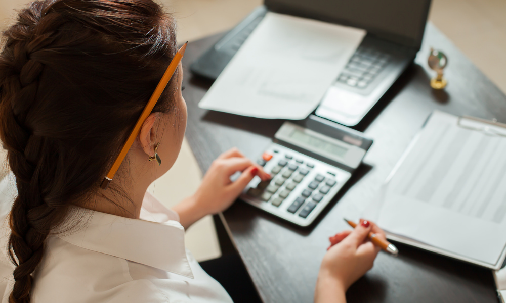 woman performing double-entry bookkeeping