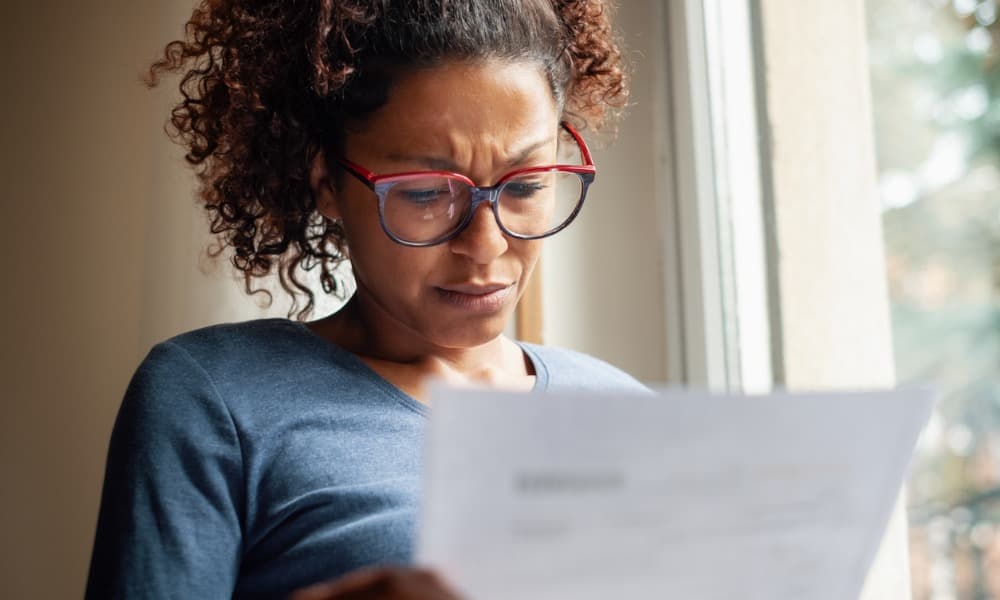 Frustrated woman looking at a tax document