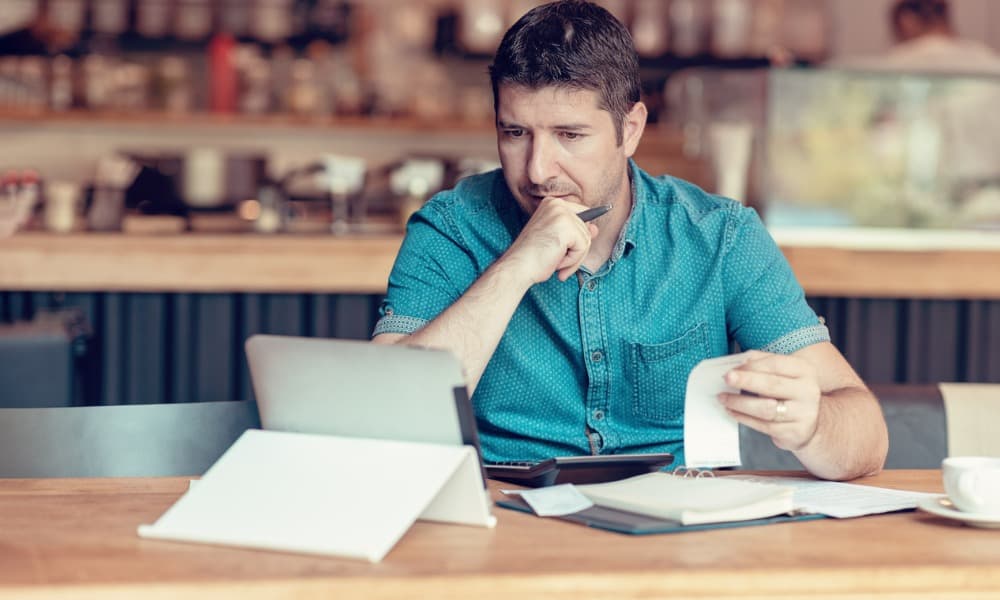 Man considering small business accounting issues on his computer