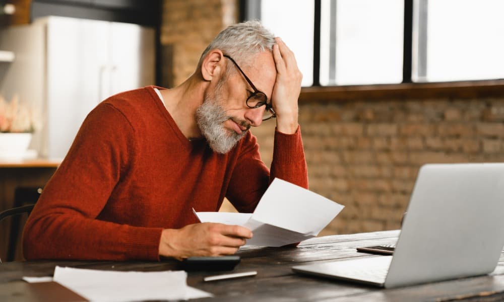 Worried man reading a tax notice about the IRS negligence penalty