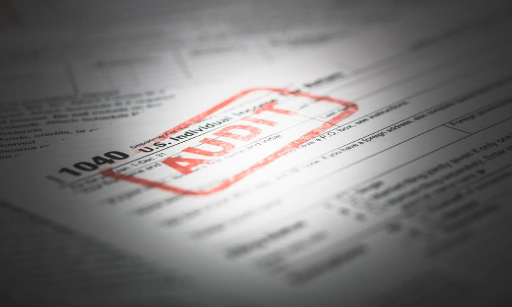 A tax return form with a red audit stamp placed during an IRS contractor audit.