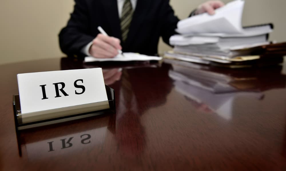 IRS tax auditor reviewing business documents on a desk for a shareholder IRS audit