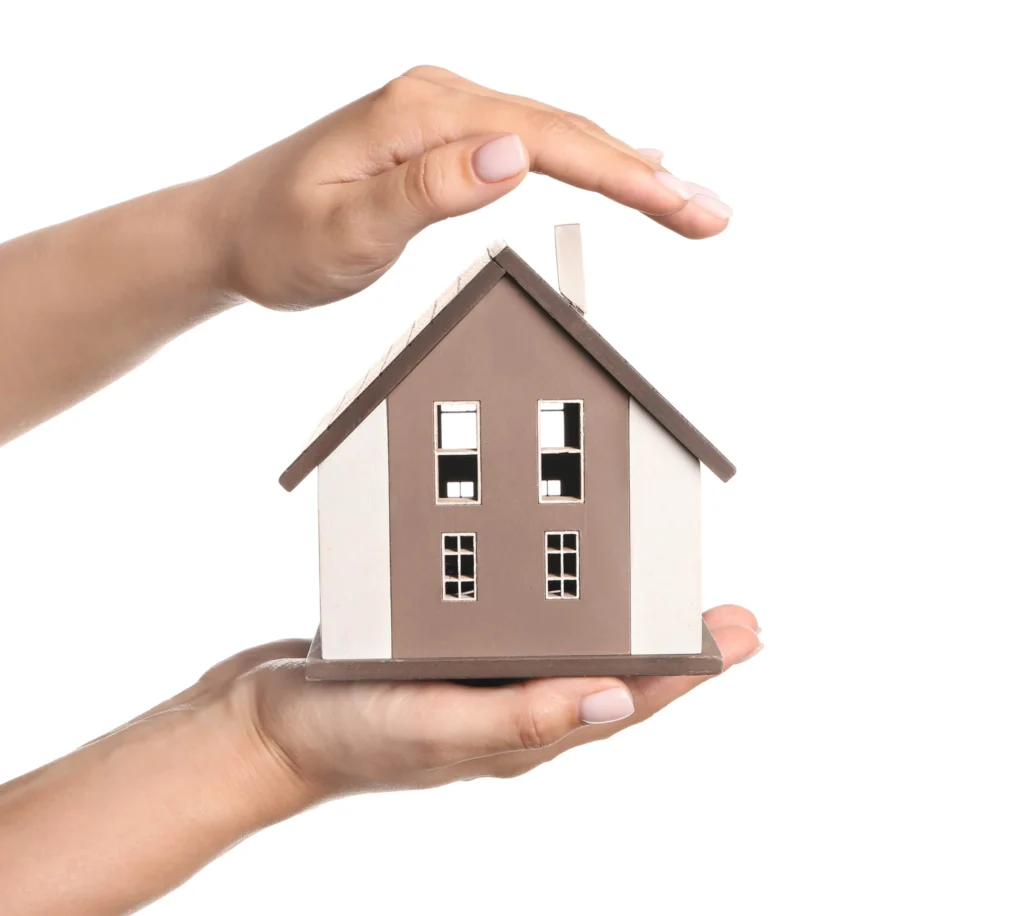 A person holding a toy house.