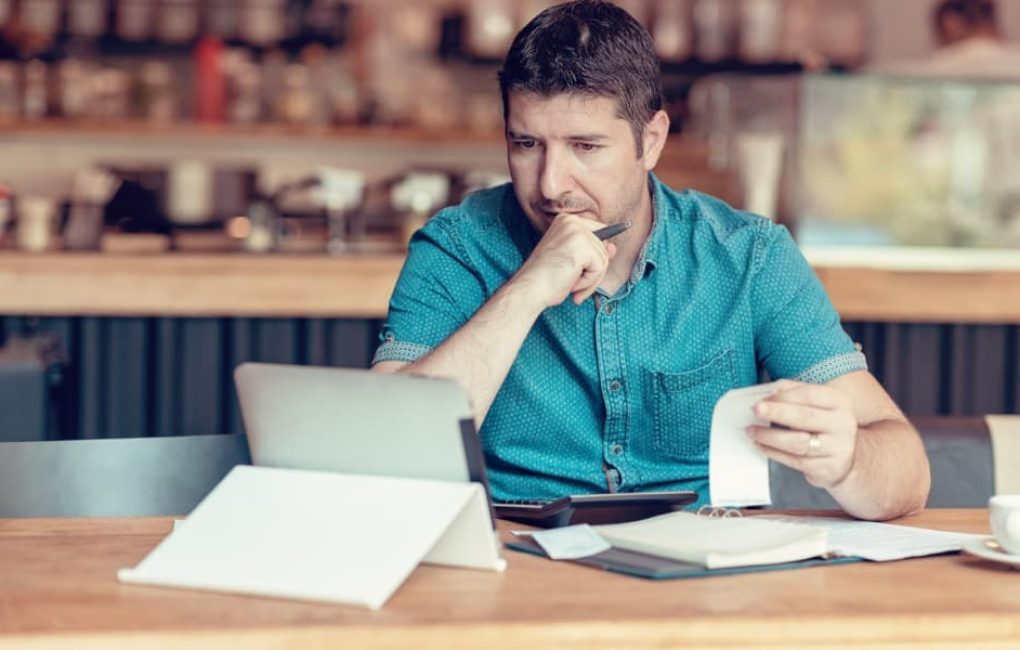 Man Considering Small Business Accounting Issues On His Computer