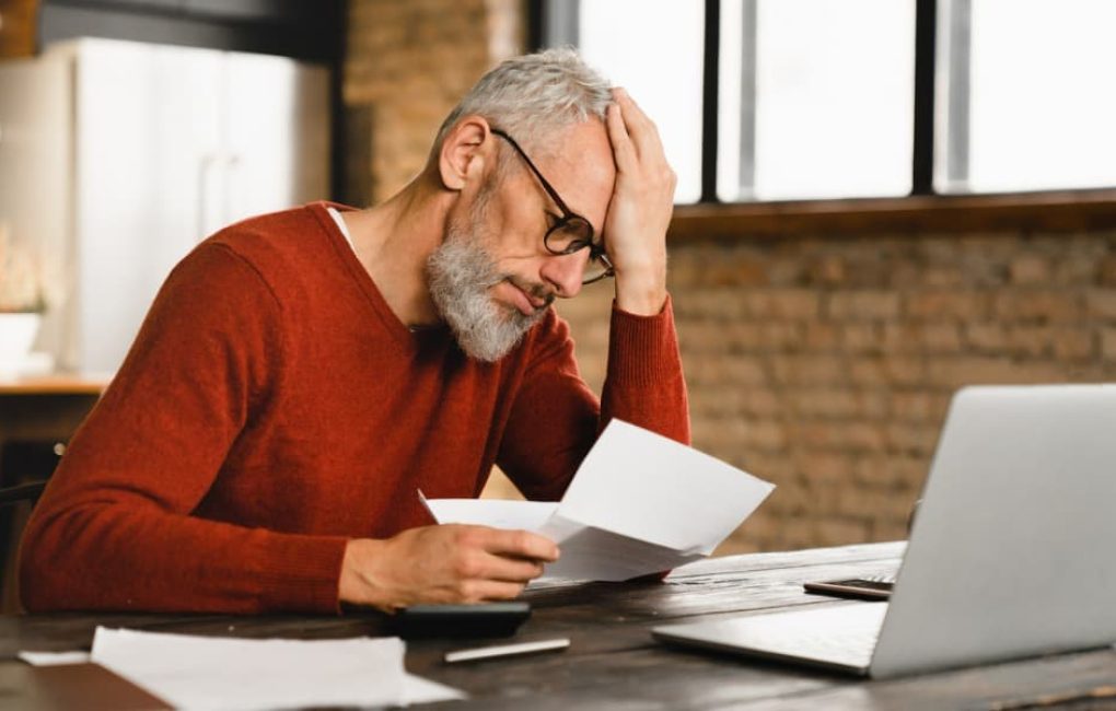 Worried Man Reading A Tax Notice About The Irs Negligence Penalty